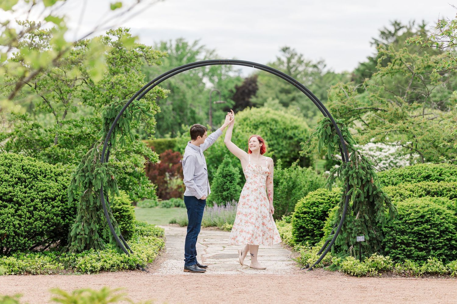 Beautiful moment captured under a garden archway surrounded by green foliage and landscaped hedges at Cantigny Park