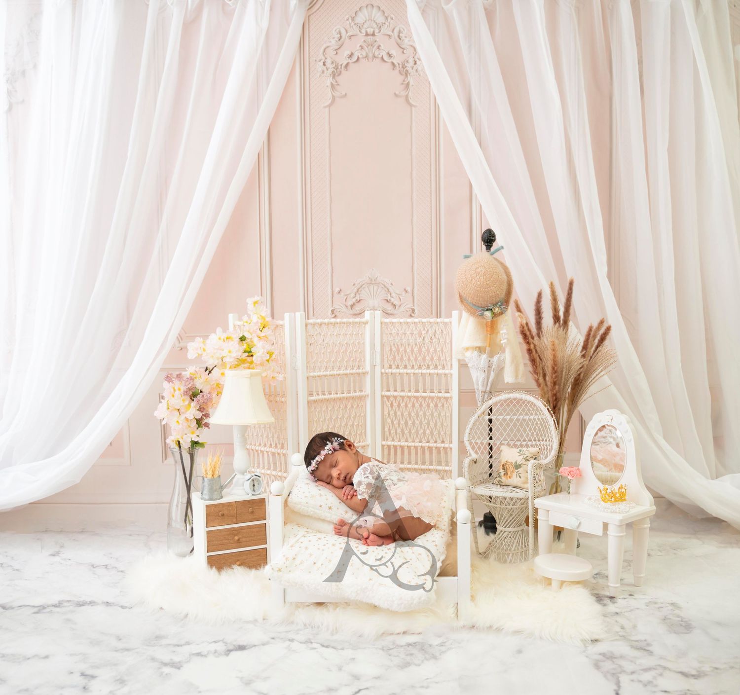 Dreamy white photo setup with draped curtains, wicker furniture and bohemian decor elements.