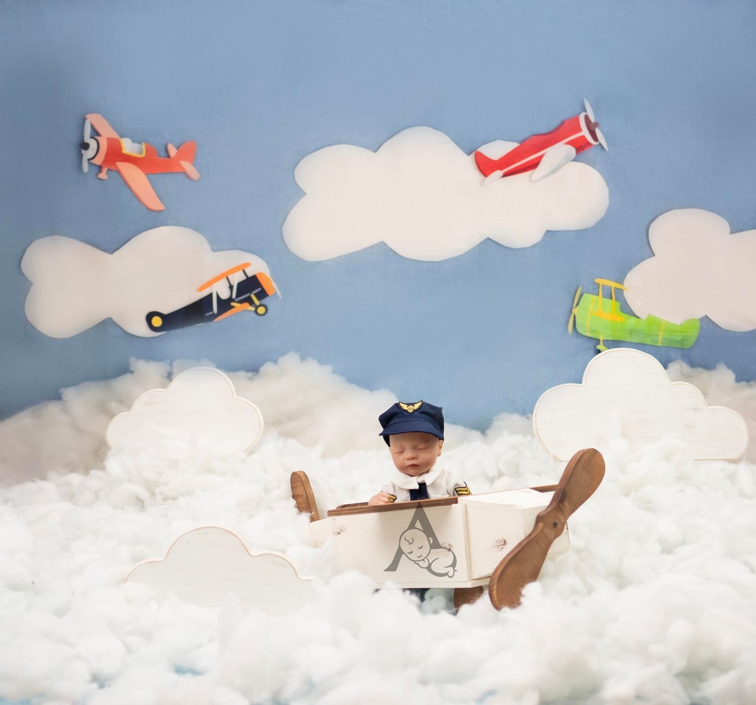 Creative child's photo composition with toy planes flying through cotton cloud backdrop.