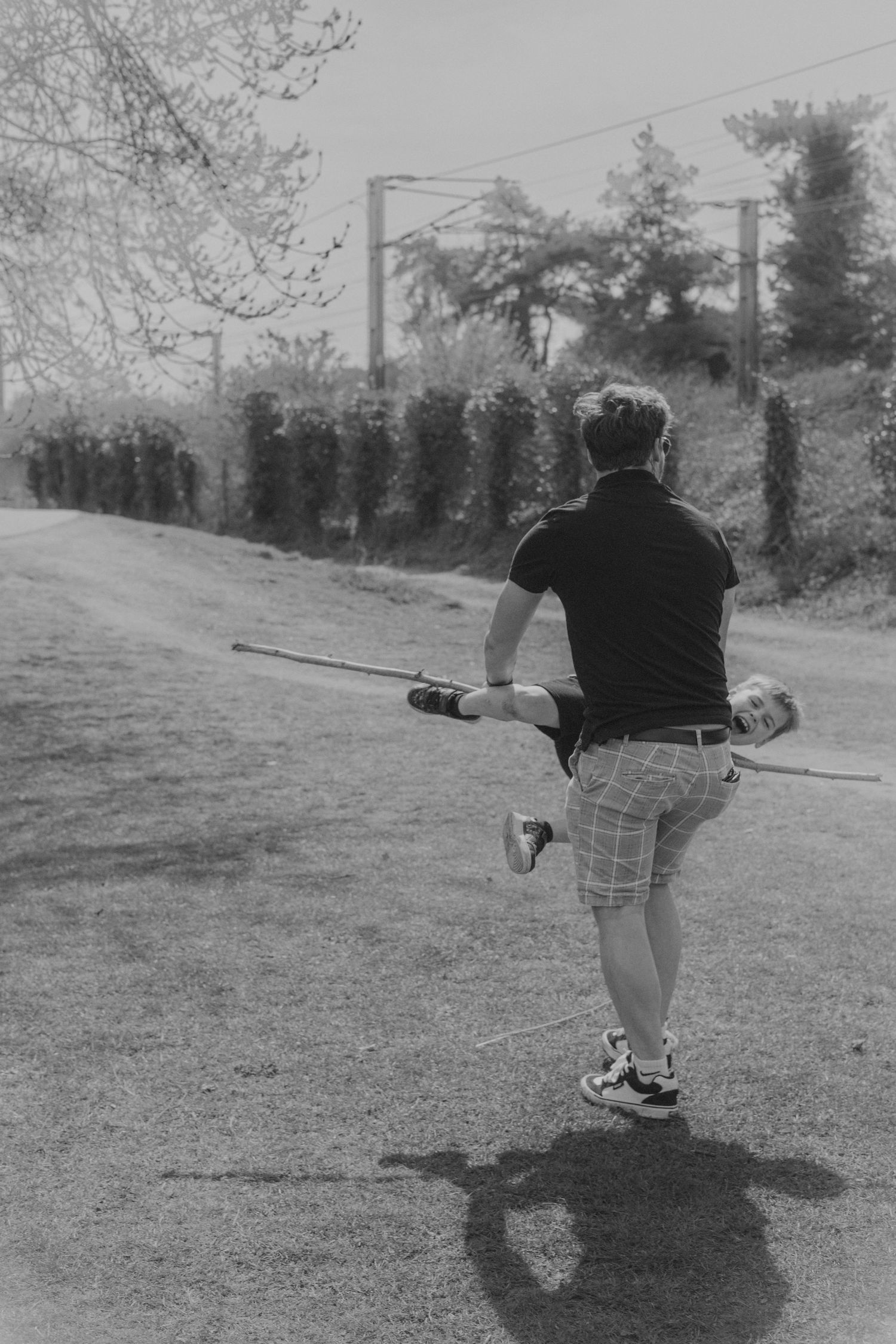 dad and son playing in Needham Lake parks ,monochrome