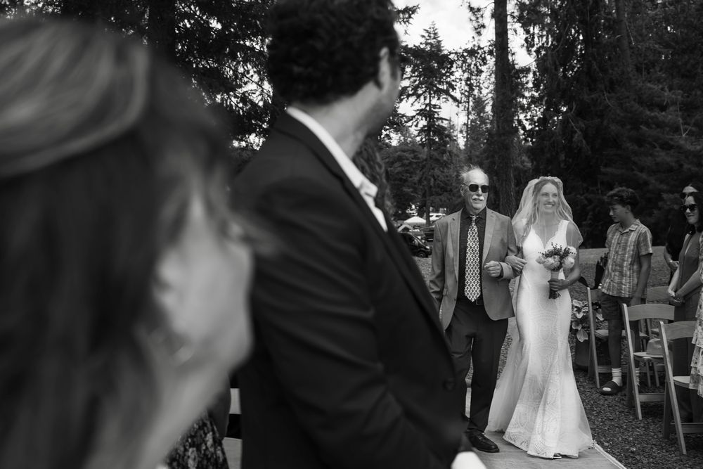 A romantic black and white outdoor wedding photo sequence showing candid moments during a celebration.