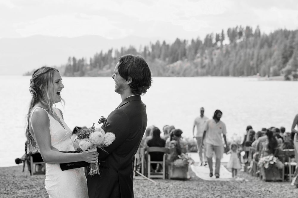 A series of candid moments at an outdoor lakeside wedding celebration with people gathered under cloudy skies.