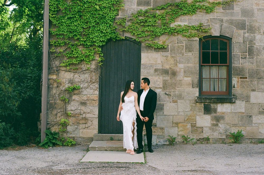 Stone building exterior covered with lush green ivy creates a romantic backdrop.