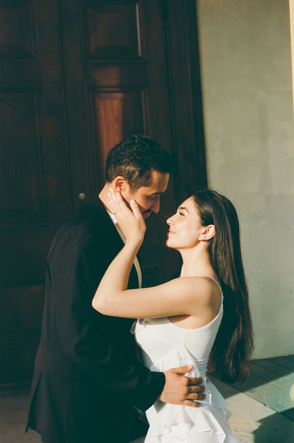 A couple in wedding attire shares intimate poses in an indoor photoshoot sequence.