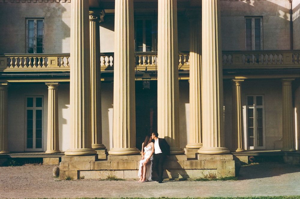 Neoclassical building facade features impressive white columns and ornate architectural details.