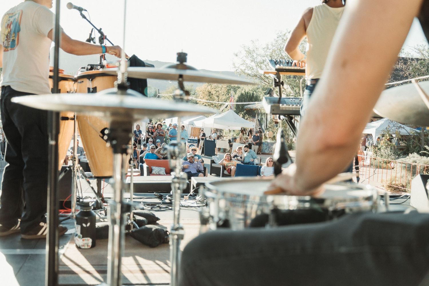 Close-up view of musical equipment and instruments at outdoor performance.