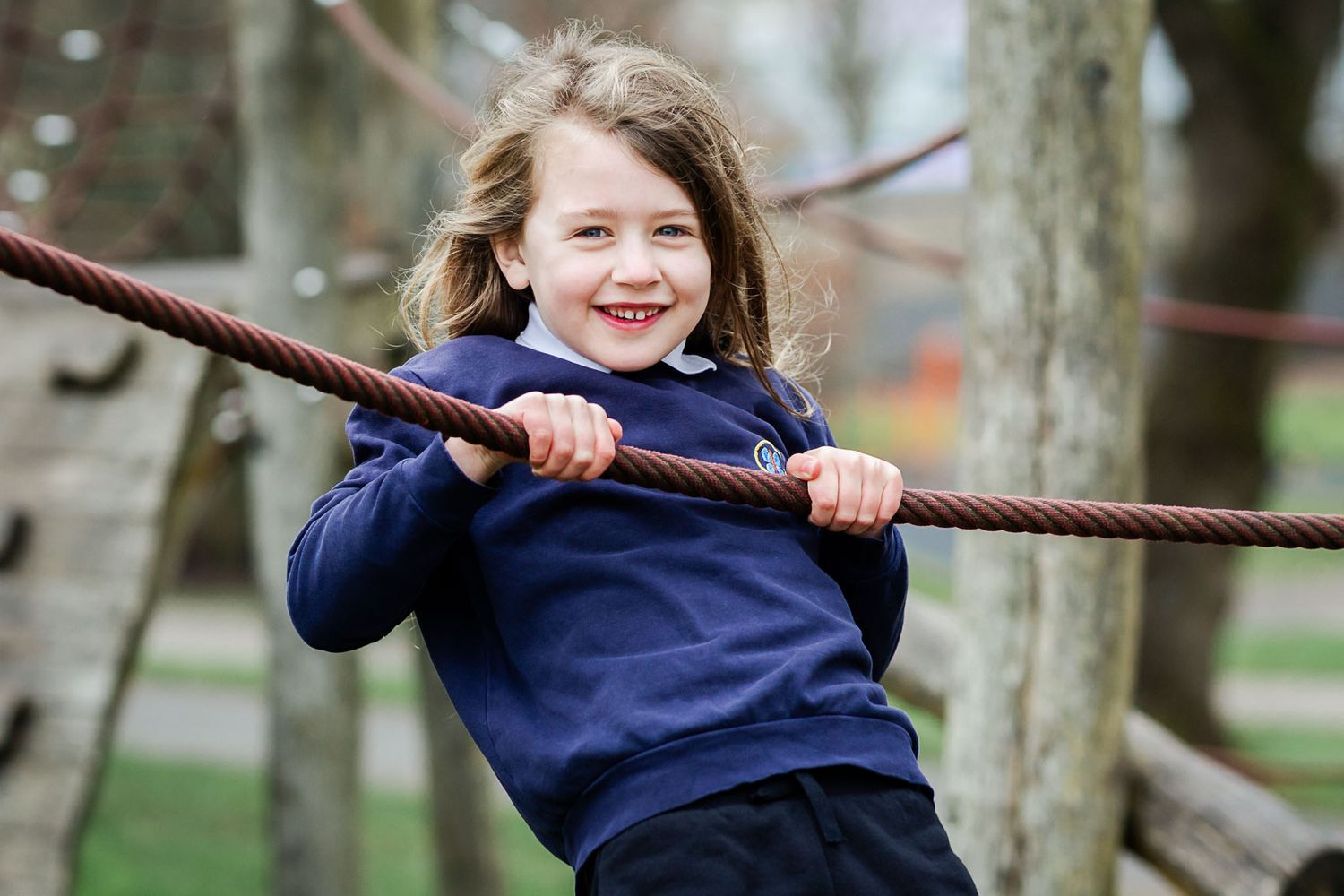 A primary child looks relaxed as he has his school photo taken outdoors. Bristol school photographer
