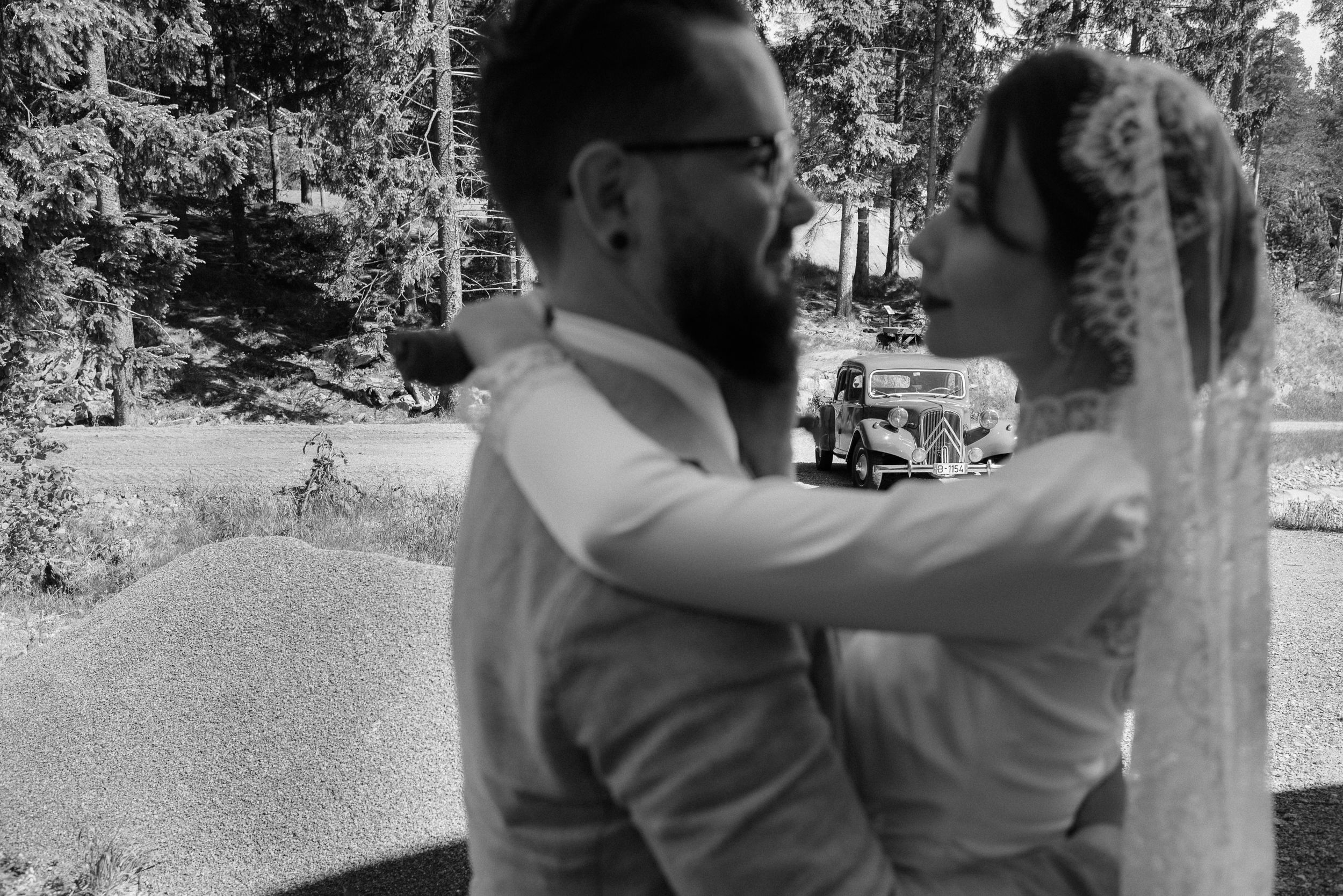 A tender black and white moment between newlyweds outdoors.