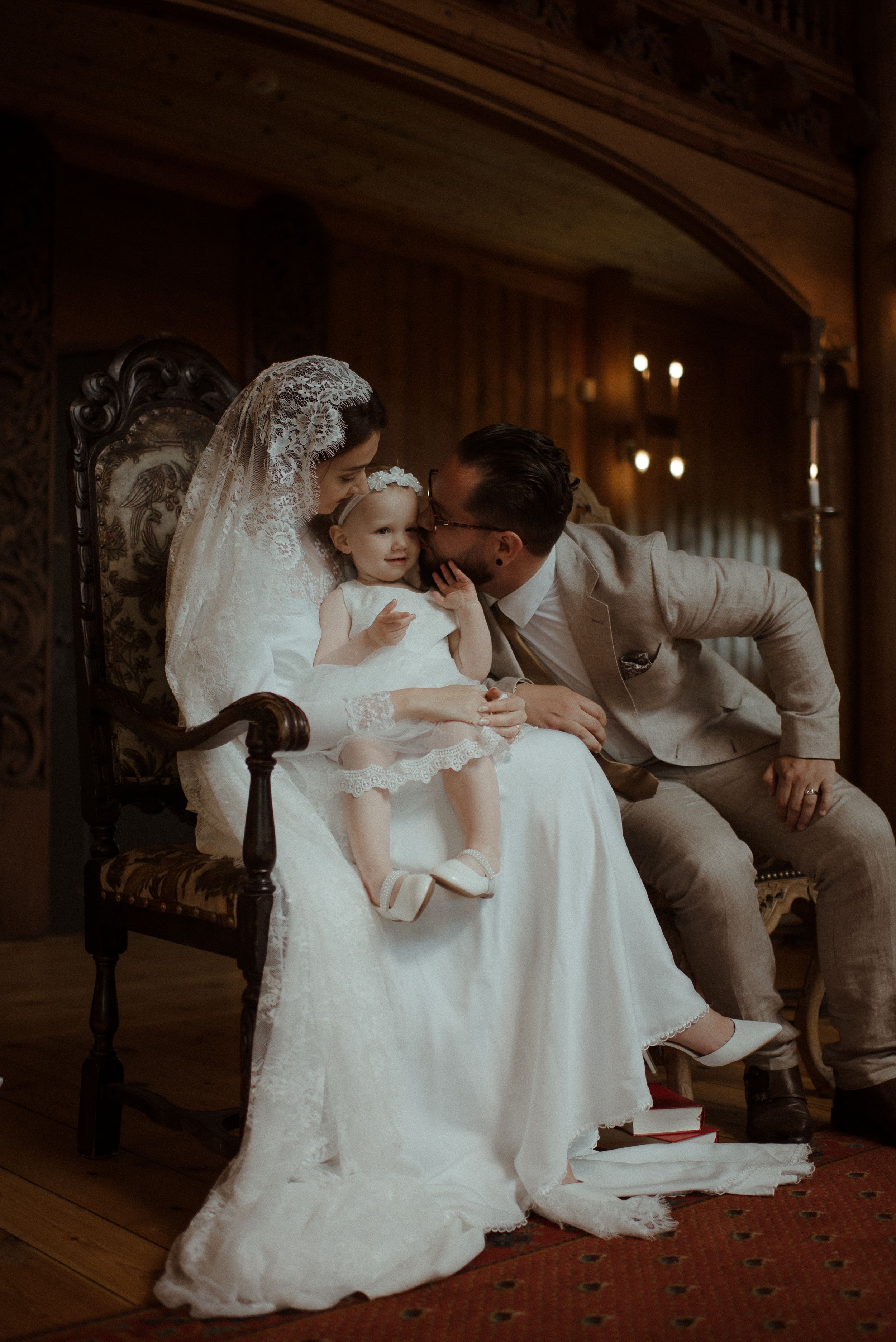 An intimate wedding moment captured in a vintage-style setting with elegant decor and warm lighting.