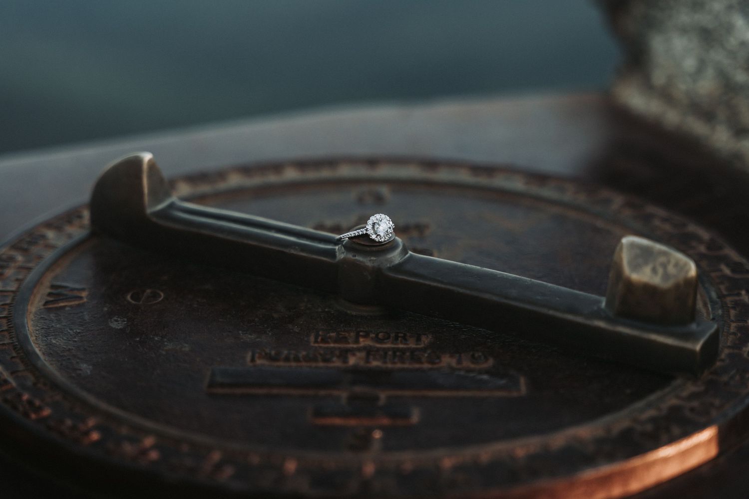 Close-up of an engagement ring with oval diamond on a woman's hand.