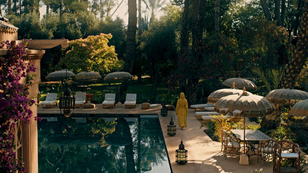 Tranquil poolside retreat surrounded by lush gardens and comfortable lounge chairs at a luxury resort.