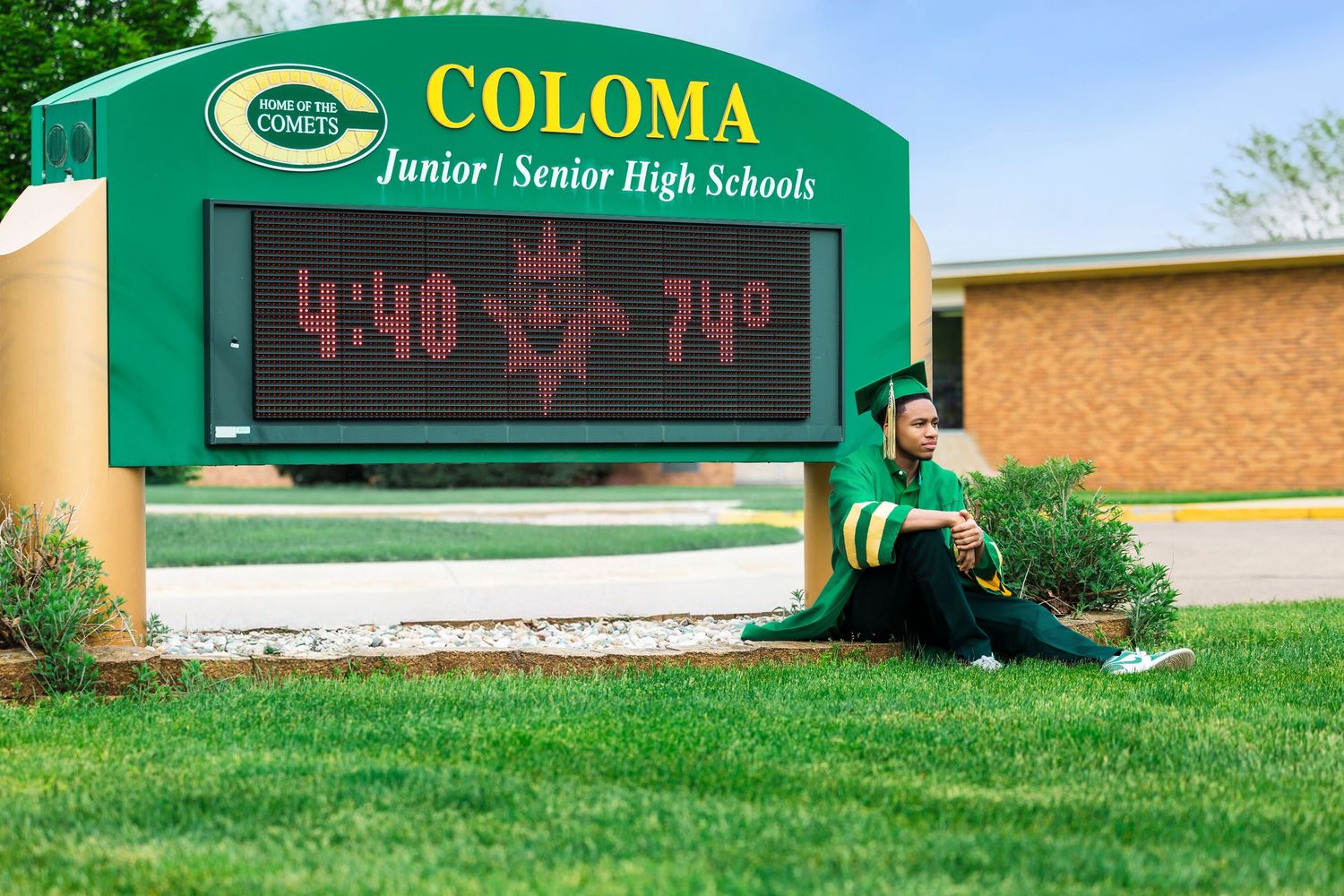 Southwest Michigan senior standing proudly in graduation attire in Coloma MI