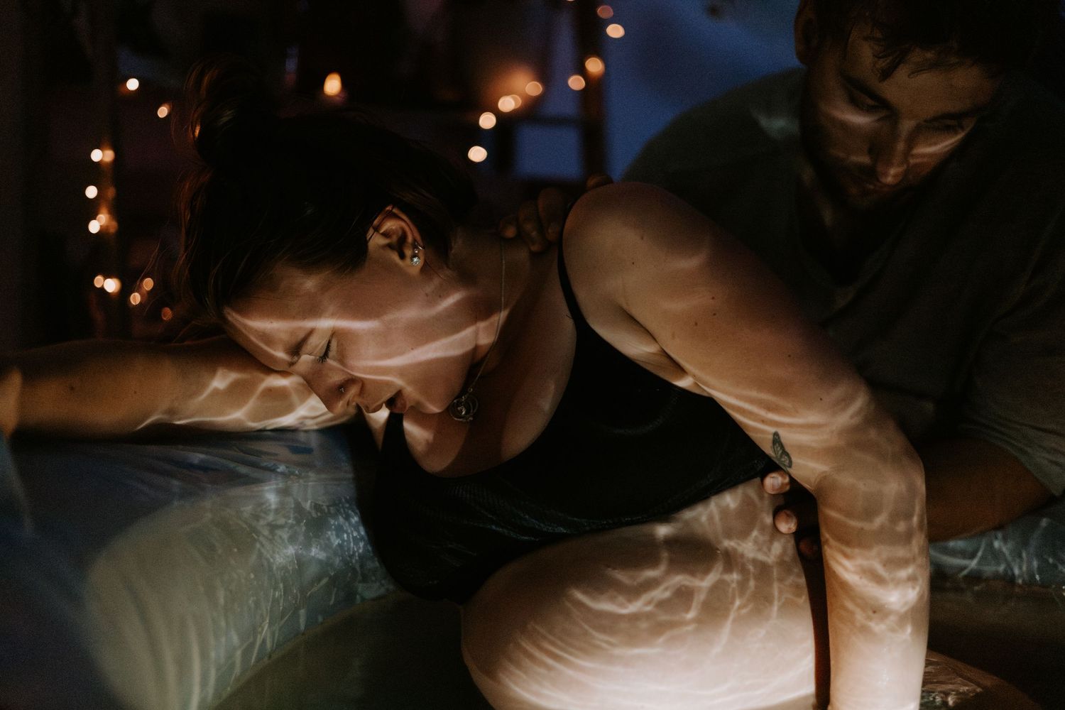 People sitting at a dark restaurant table lighting and blowing on hot food with steam rising in a dramatic atmosphere.