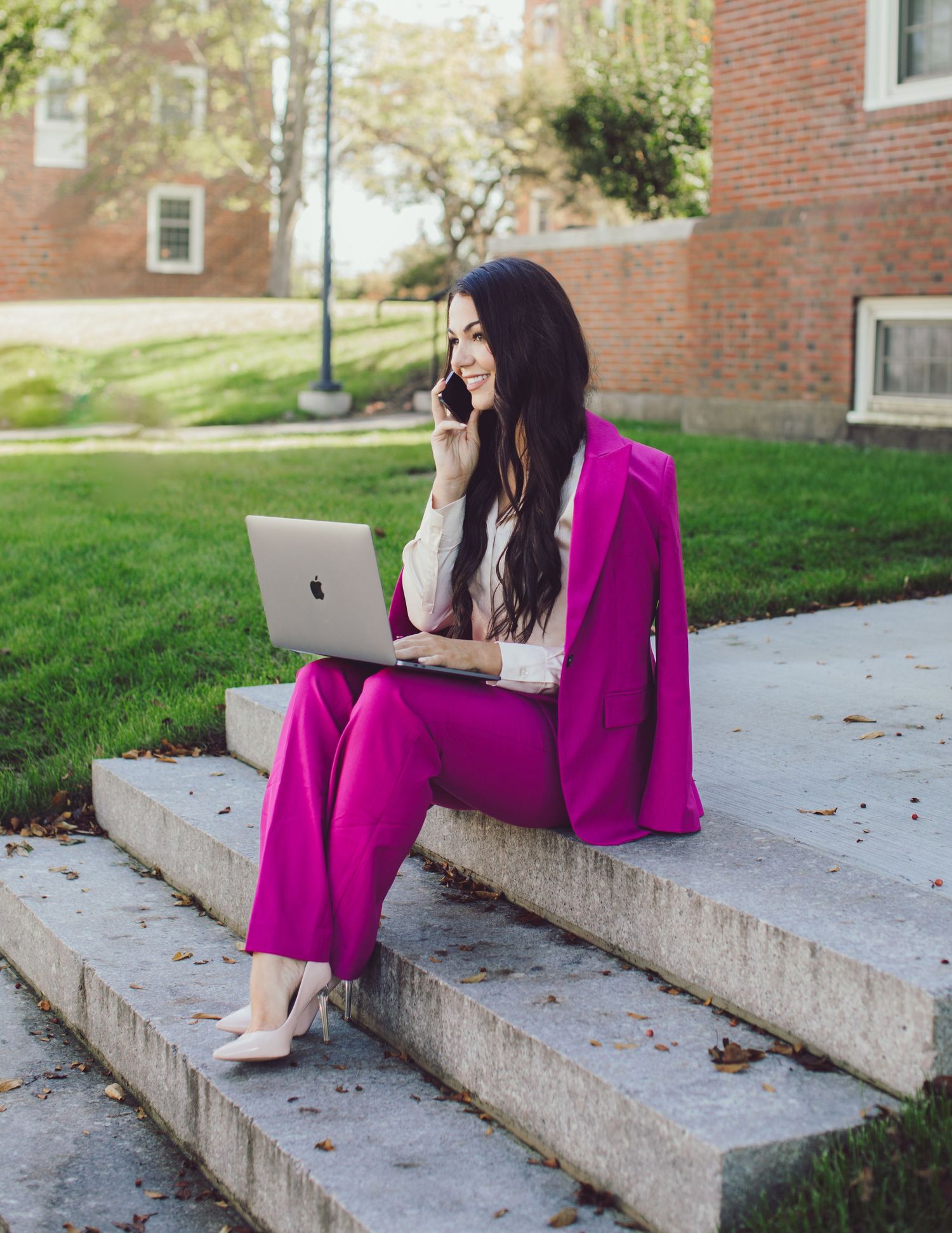 Professional photo of a woman talking on the phone in business attire