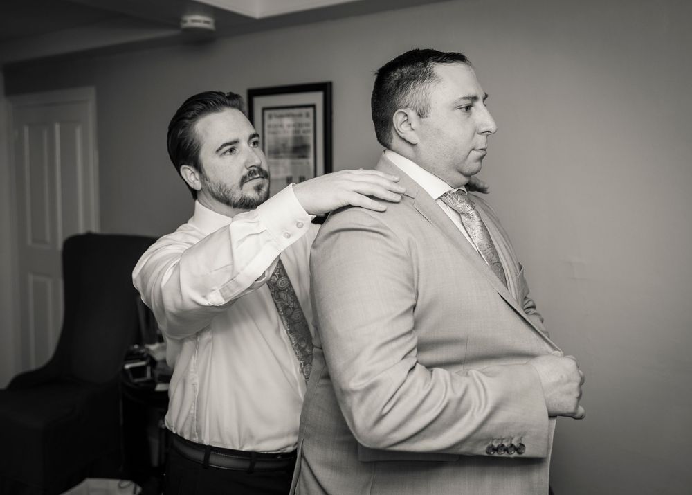 Black and white candid moments of wedding preparation.