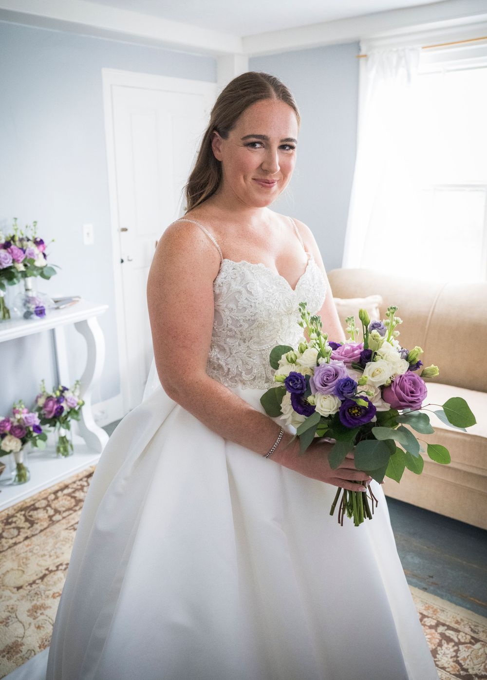 Elegant bridal portraits featuring a white ballgown wedding dress with floral bouquet in a bright room.