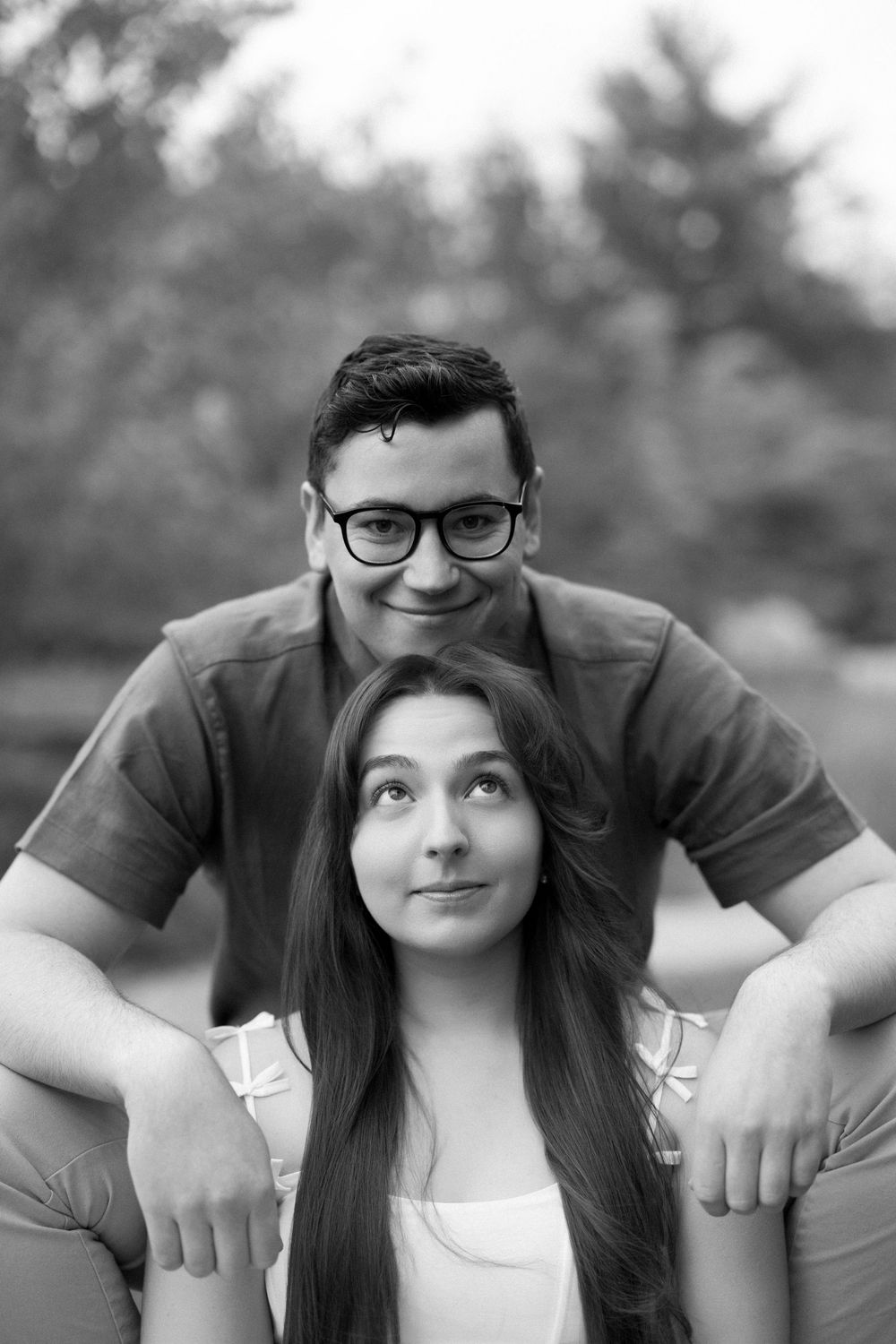 Black and white photo series of a couple posing playfully together outdoors.