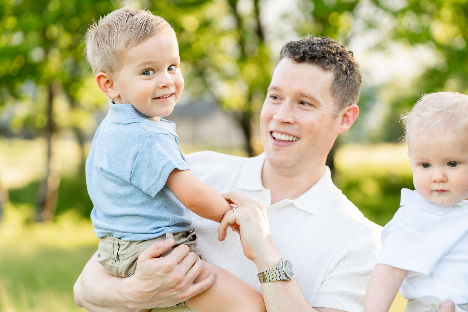 Dad looks at this smiling son.