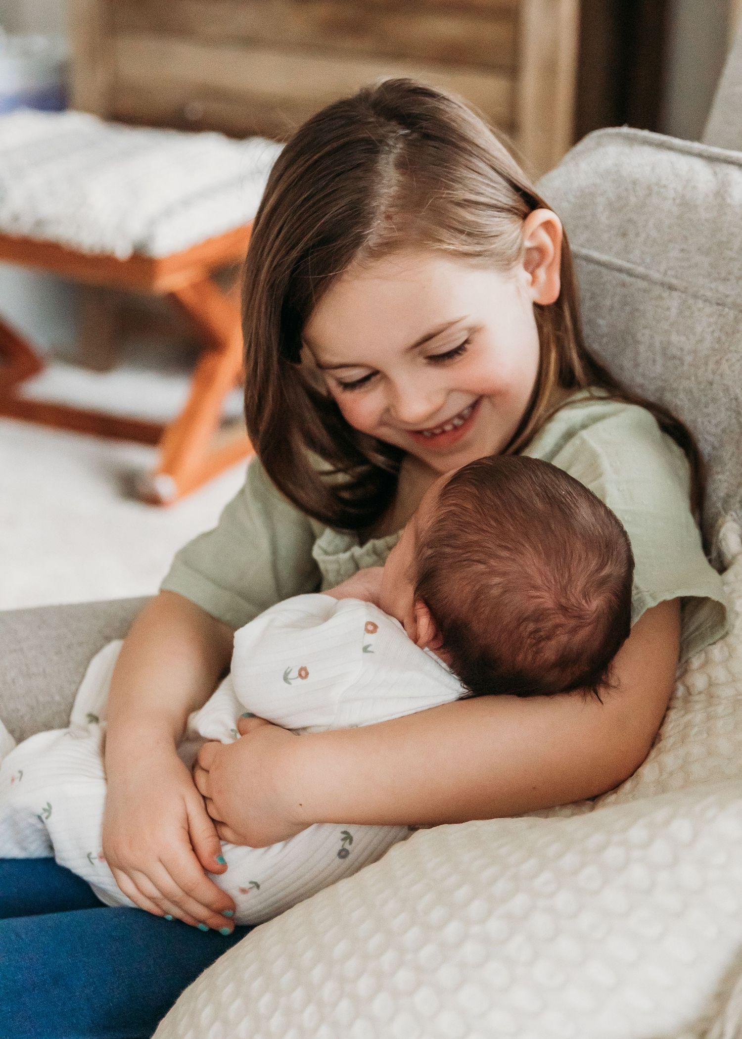 Series of tender moments showing the close bond between a small child and sleeping baby on soft bedding.