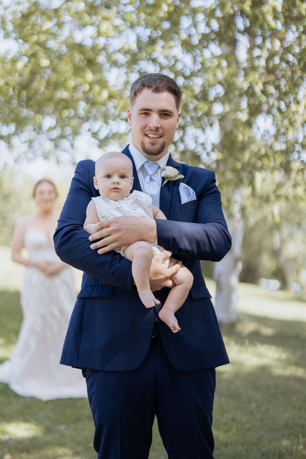 Bride and groom Pomquet Beach wedding photographer Antigonish Nova Scotia photographer first look with baby son outdoor wedding Maritime