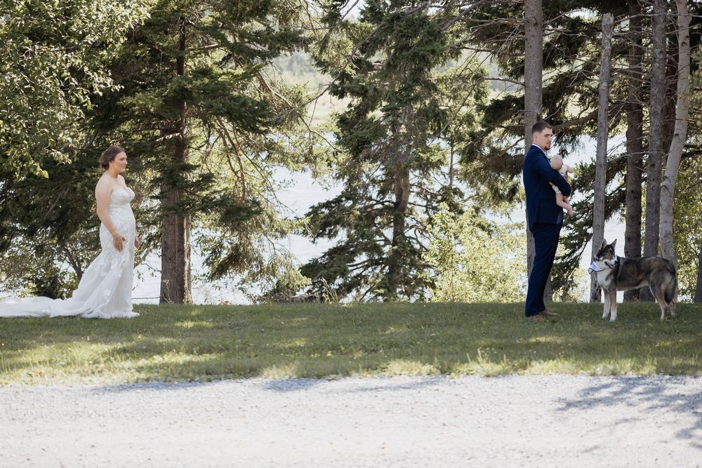 Bride and groom Pomquet Beach wedding photographer Antigonish Nova Scotia photographer first look with baby son outdoor wedding Maritime