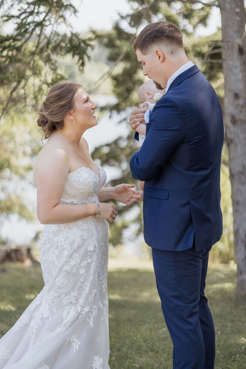 Bride and groom Pomquet Beach wedding photographer Antigonish Nova Scotia photographer first look with baby son outdoor wedding Maritime