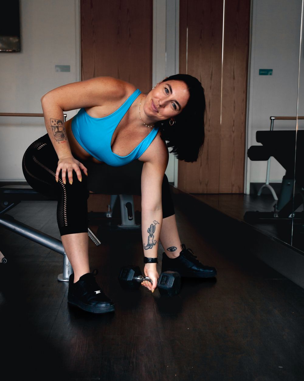 An athlete stretches on exercise equipment wearing bright blue workout attire. Brand photography, San Diego, California