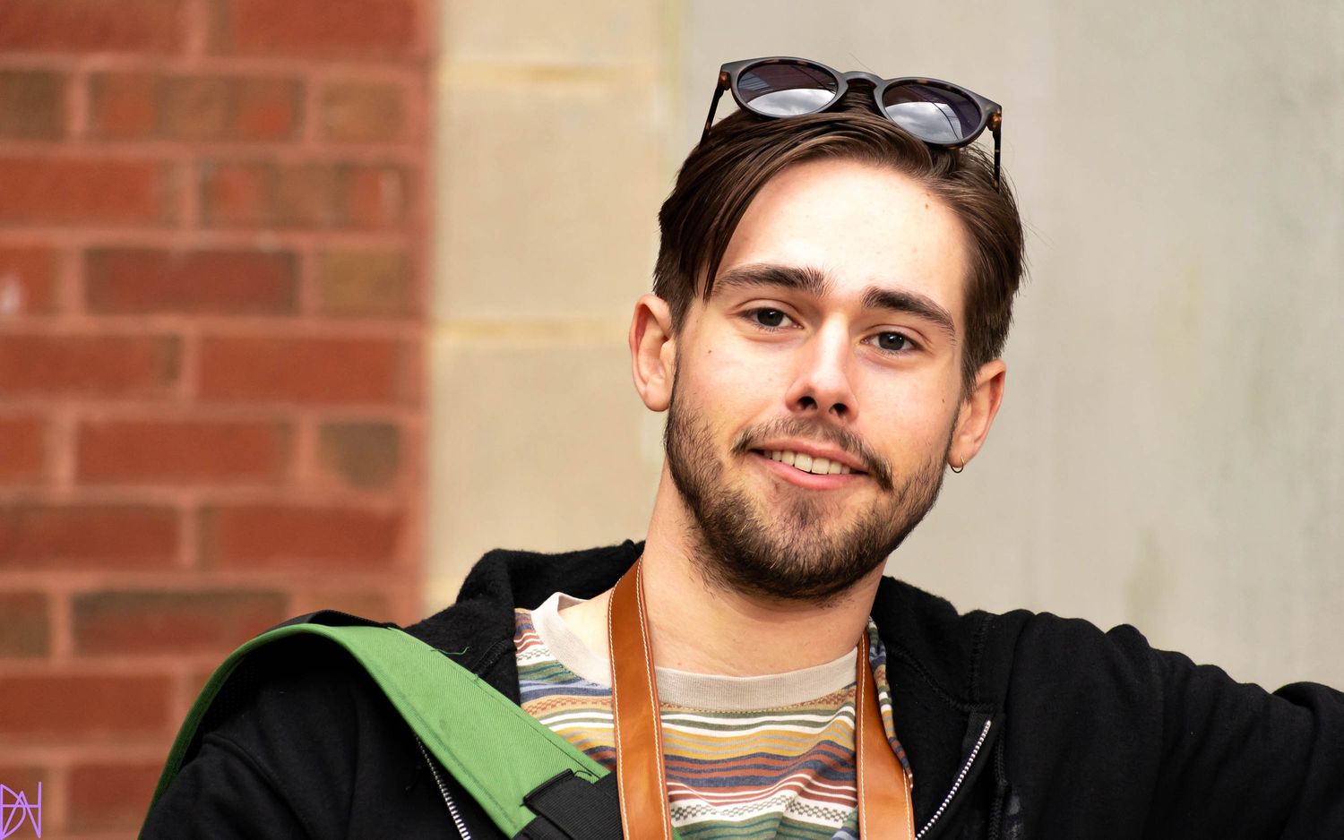 Portrait of a smiling man outdoors with natural light and relaxed energy