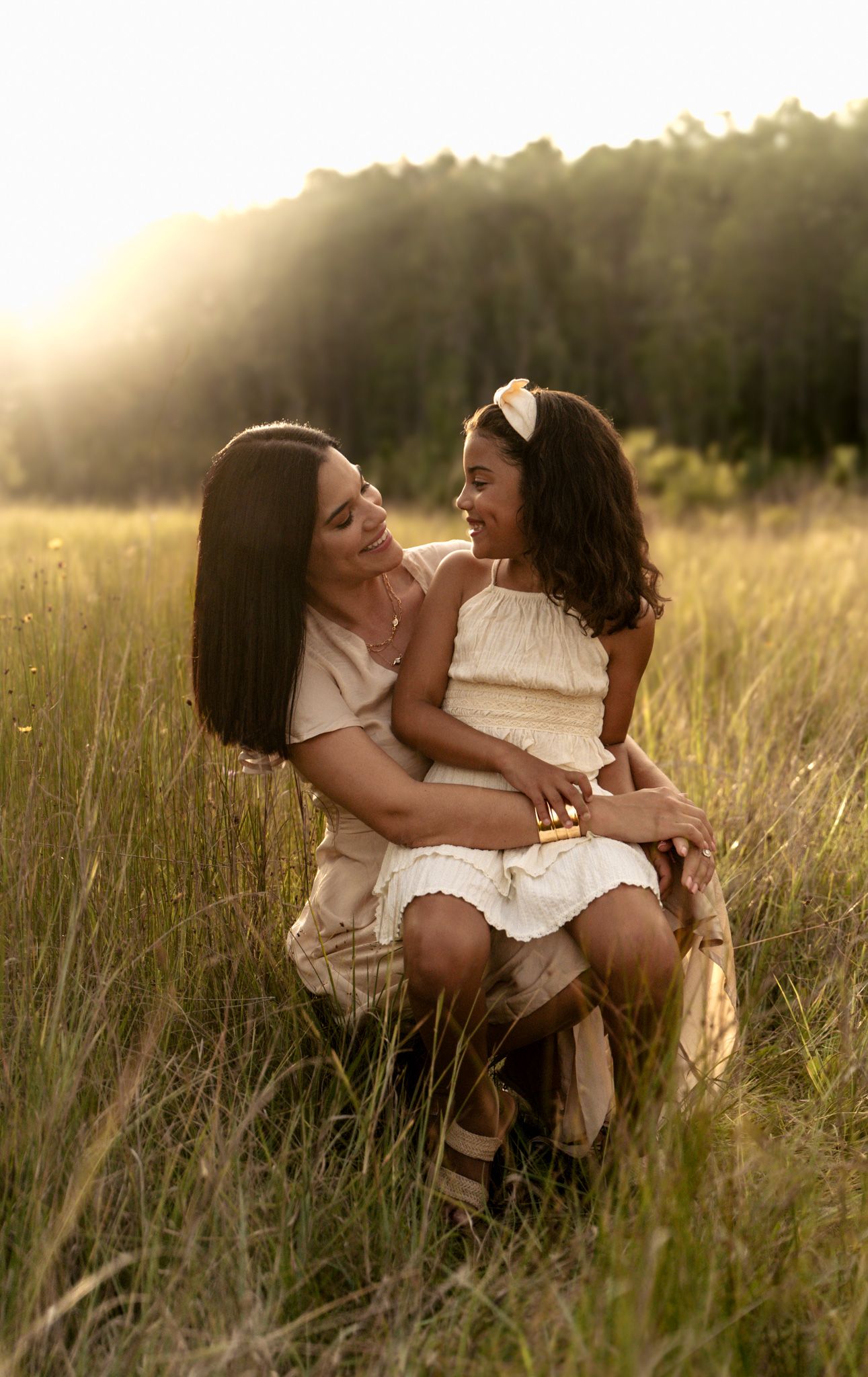 Mother and daughter in meadow portraits