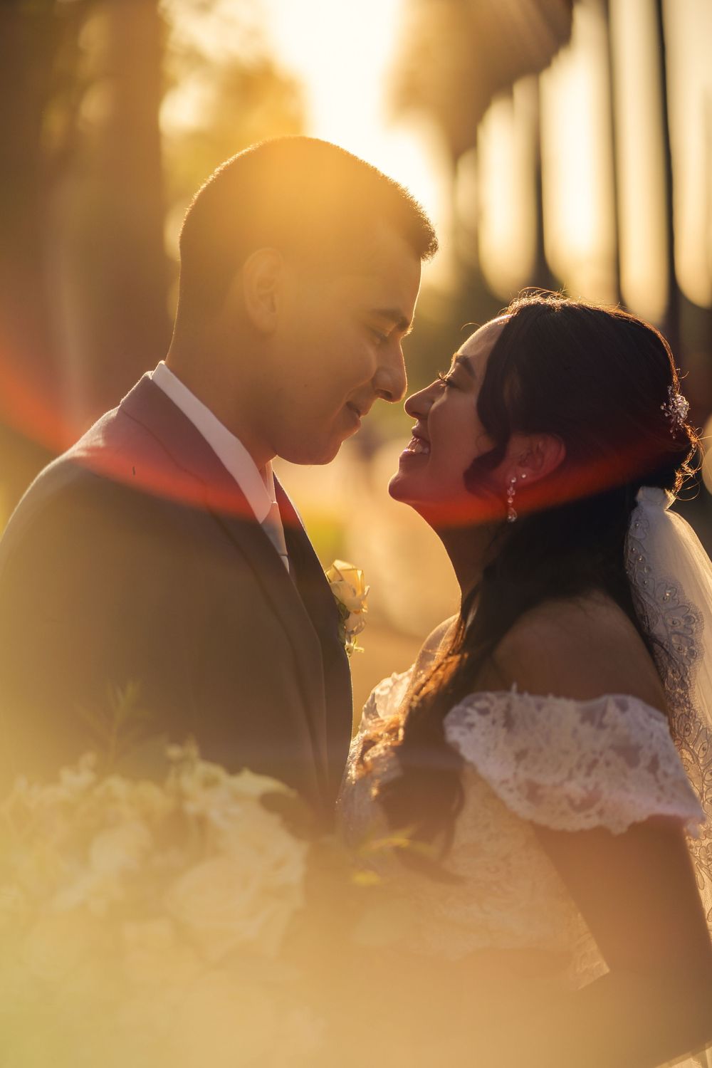Romantic newlywed couple share a moment at sunset with golden light filtering through trees during their wedding at Lindley Scott House