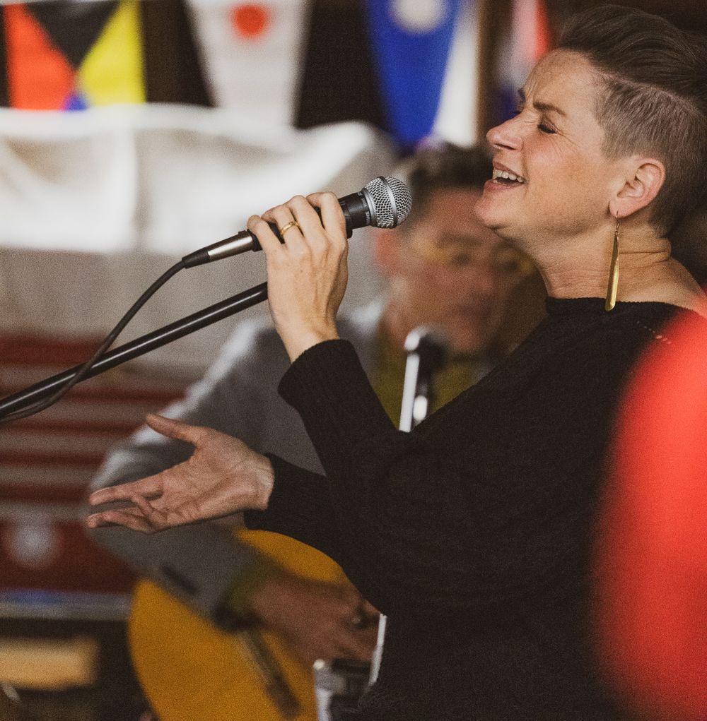 singer holding a microphone at an event