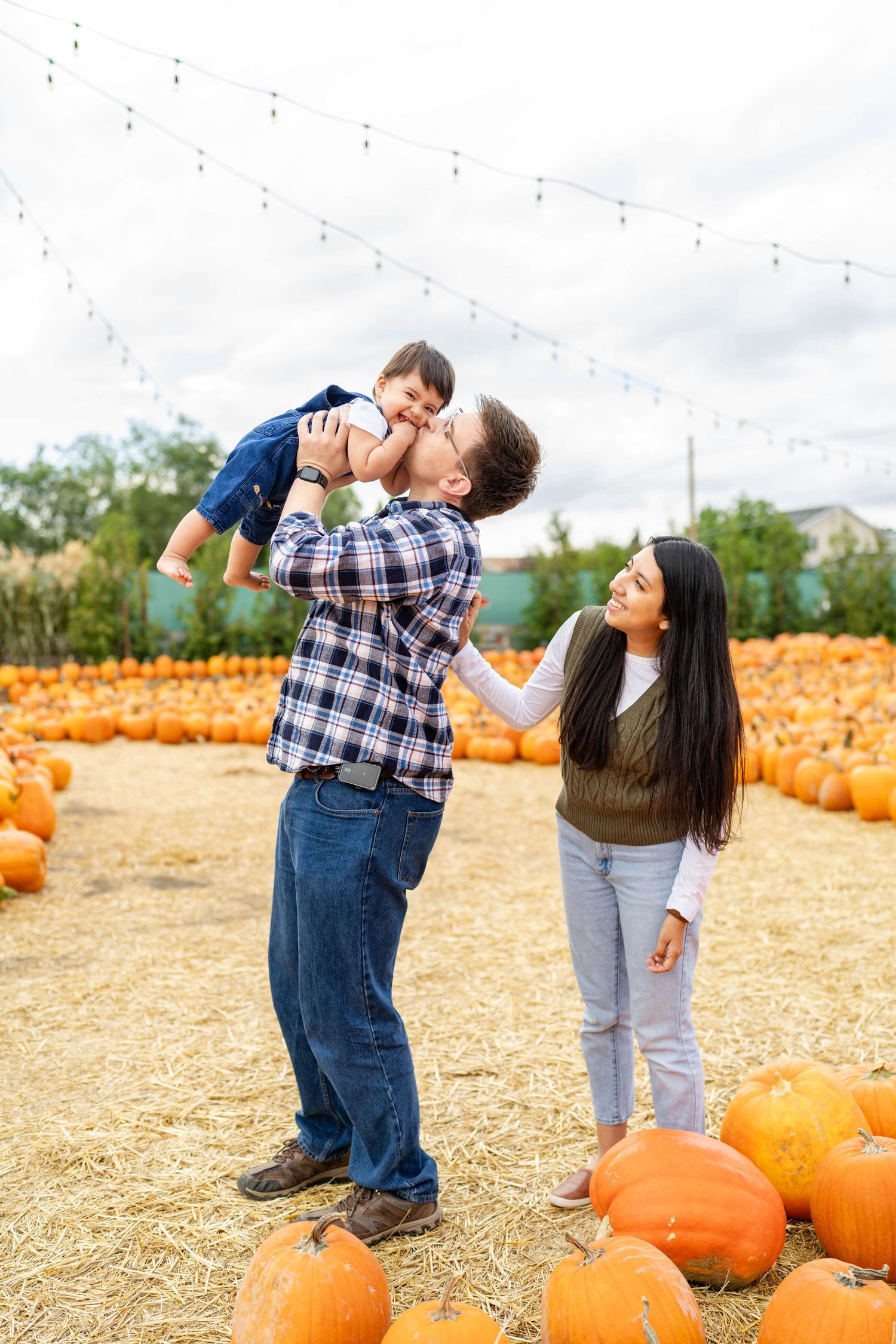 Family holding baby at Kuwahara's pumpkin patch
