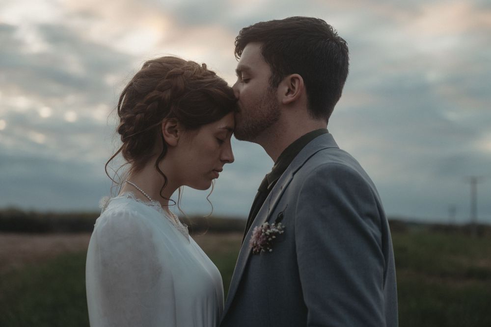 A tender moment between newlyweds during their sunset portrait session.
