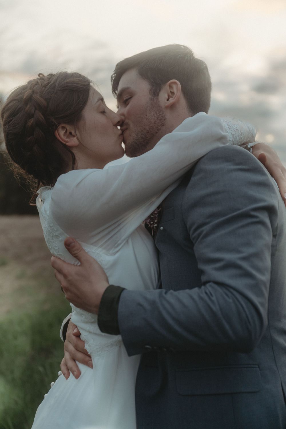 A passionate embrace between newlyweds during their sunset wedding portraits.