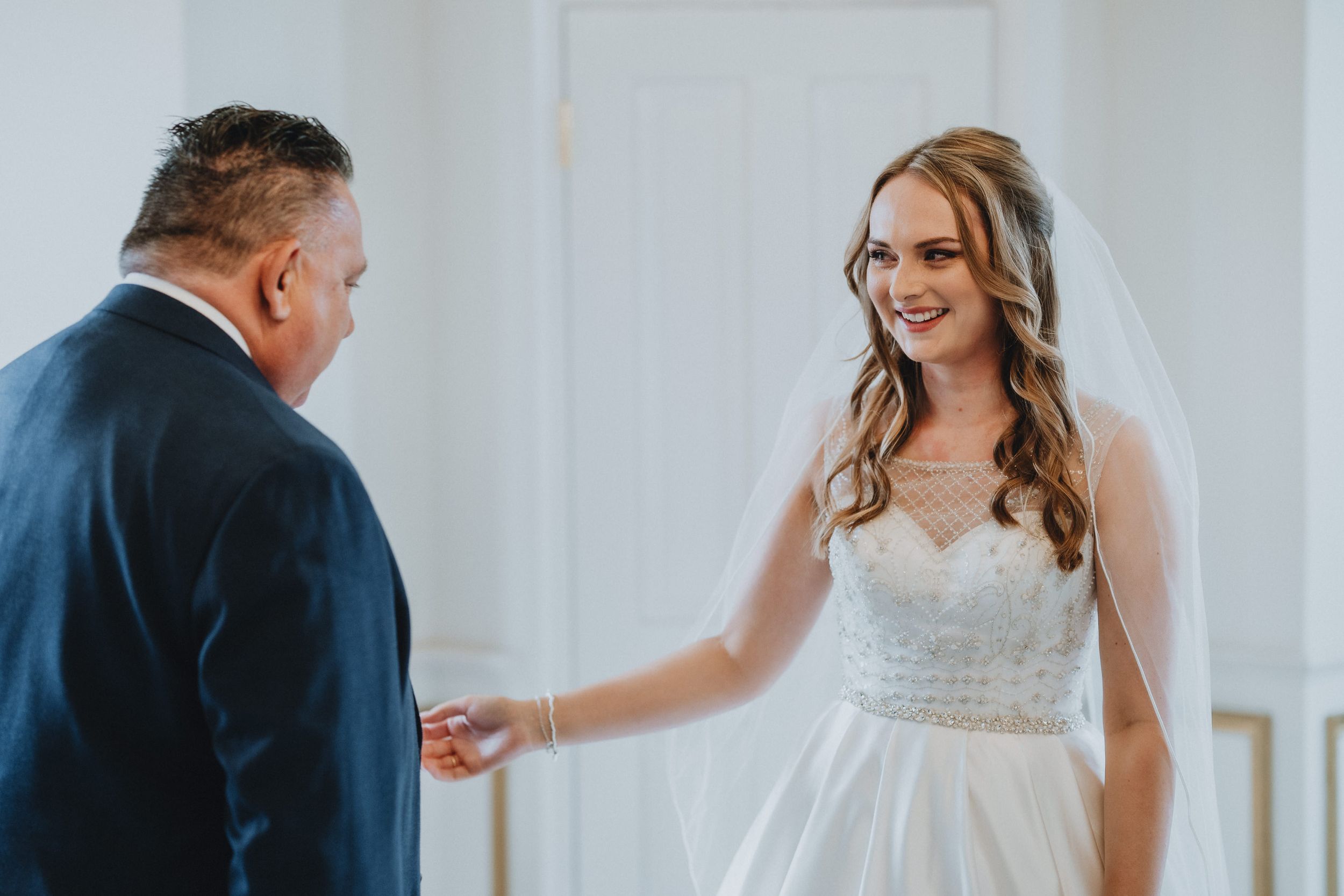 A tender moment at a wedding as a bride in a white lace gown shares a special moment with someone special.