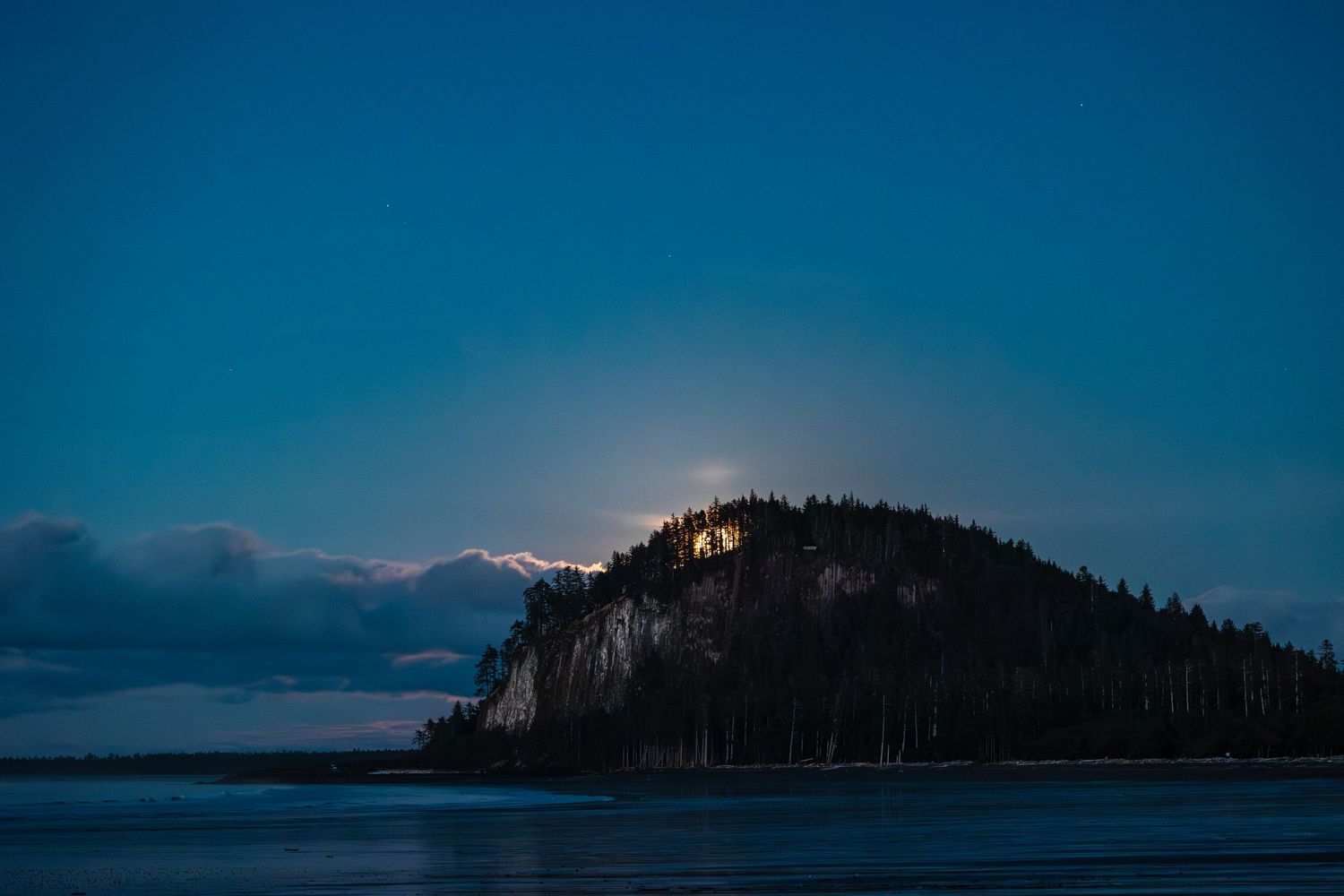 Full moon rising over Tow Hill on wedding beach on Haida Gwaii north of Masset British Columbia.