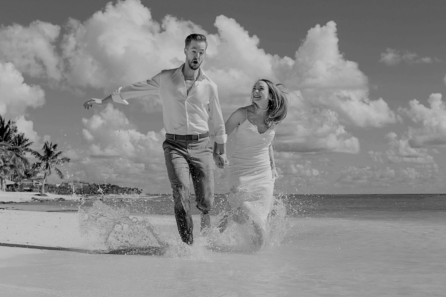 A collage of five black and white beach photographs showing people playing and splashing in ocean waves.