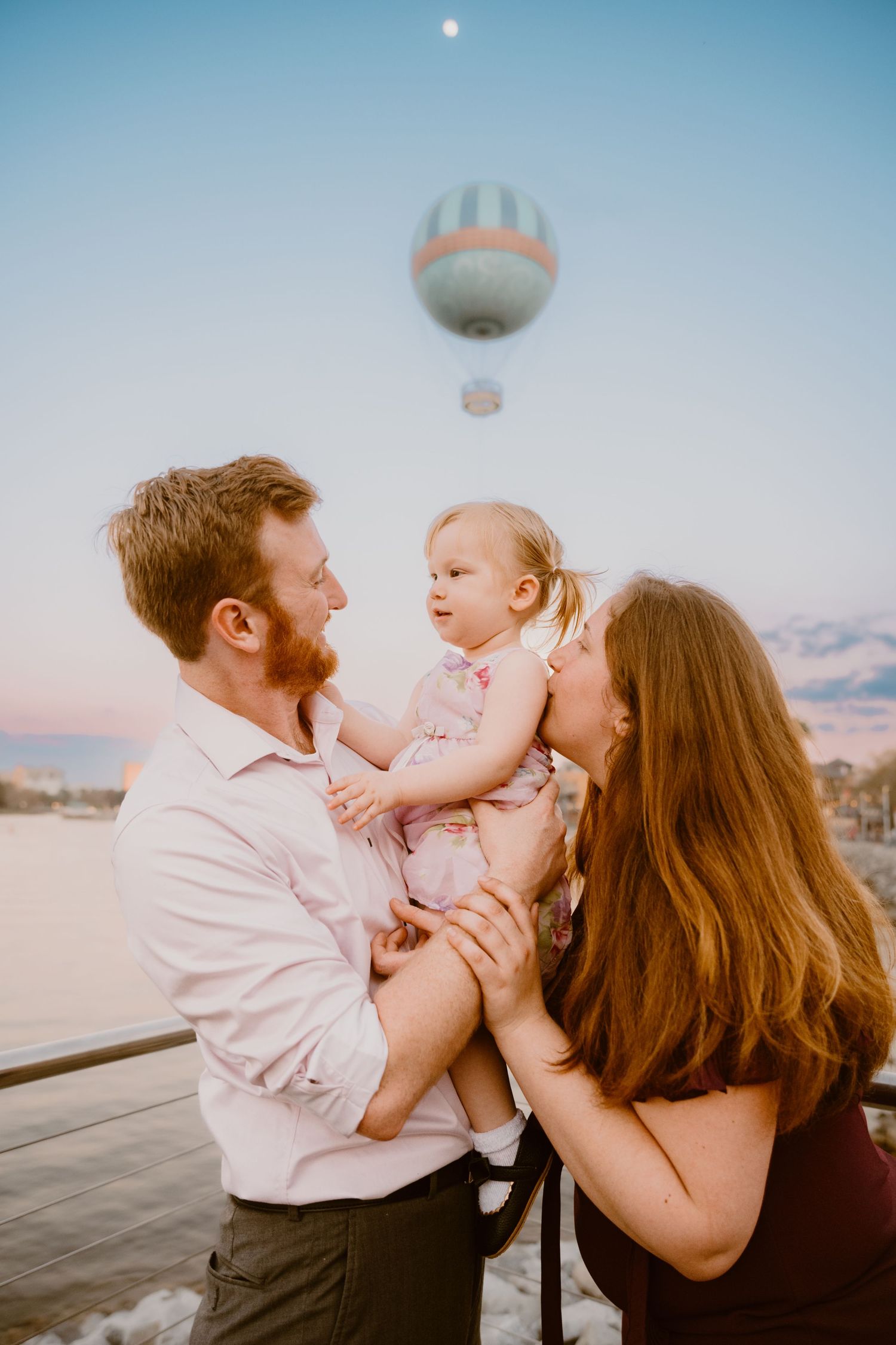 John & Emily anniversary photos at Disney Springs with baby Ripley, sunset in front of Aérophile. Cred: LexTakePix