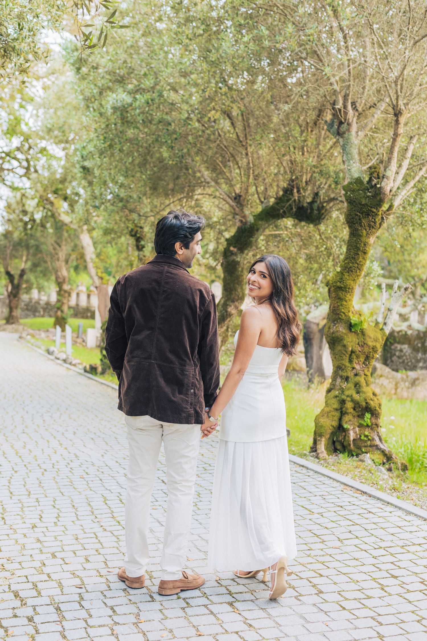 Romantic engagement photo-shoot in Sintra, Portugal, with an Indian couple exploring Penha Longa. By a destination wedding Photographer