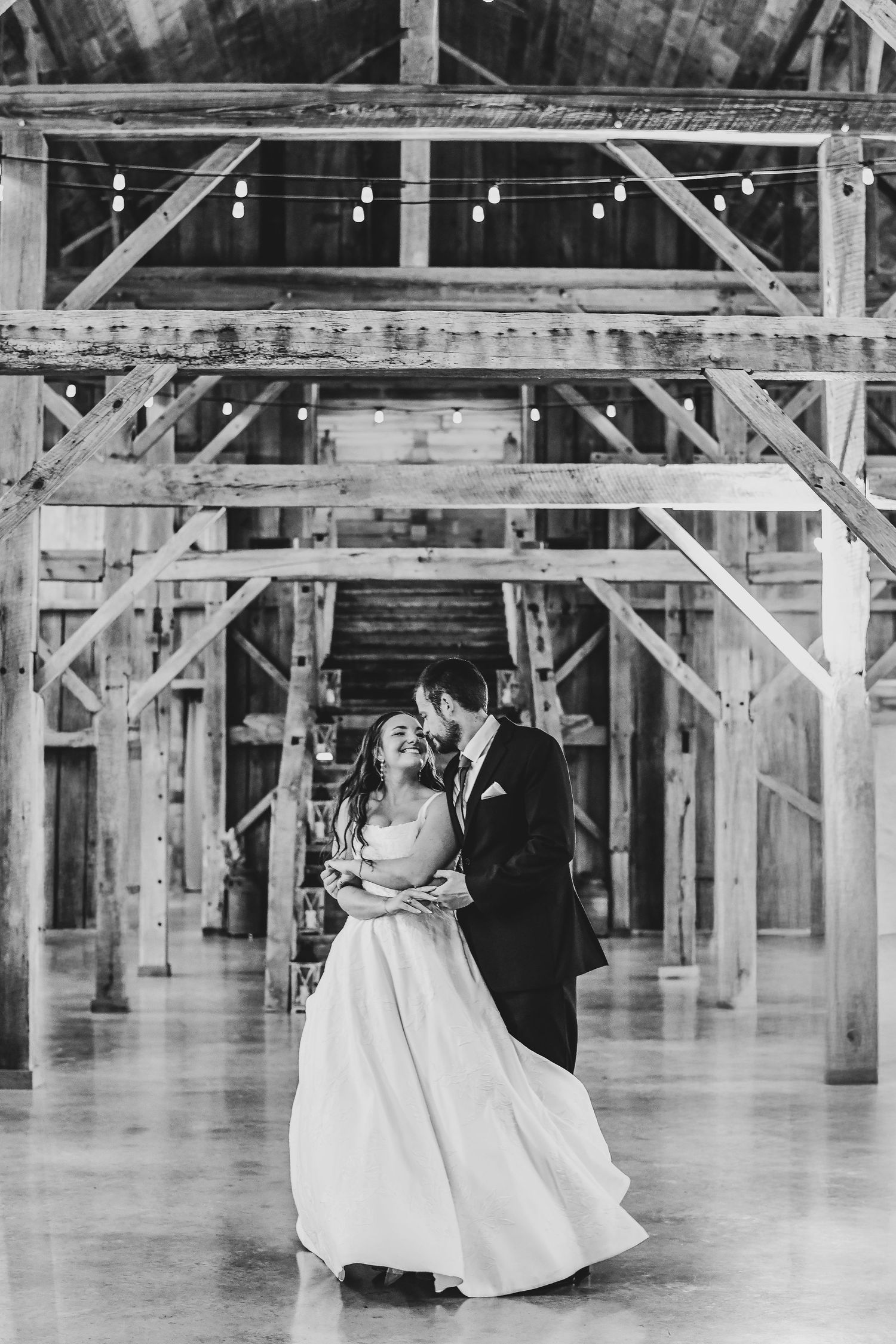 a black and white photo of the bride and groom dipping for their first dance at their collinsville wedding venue