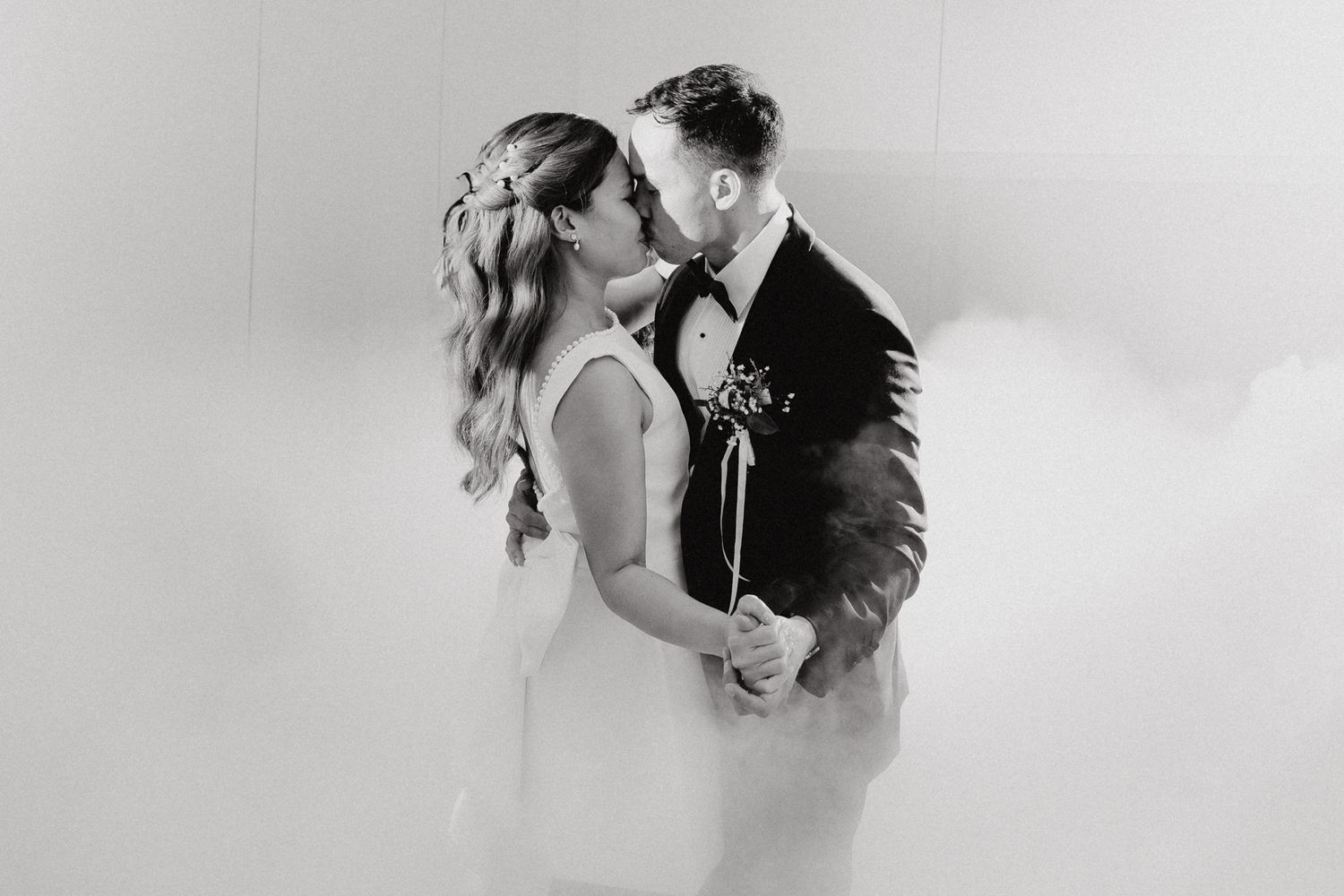 A romantic portrait of a bride and groom sharing an intimate moment captured by Apertured Media Auckland Wedding Photographer.