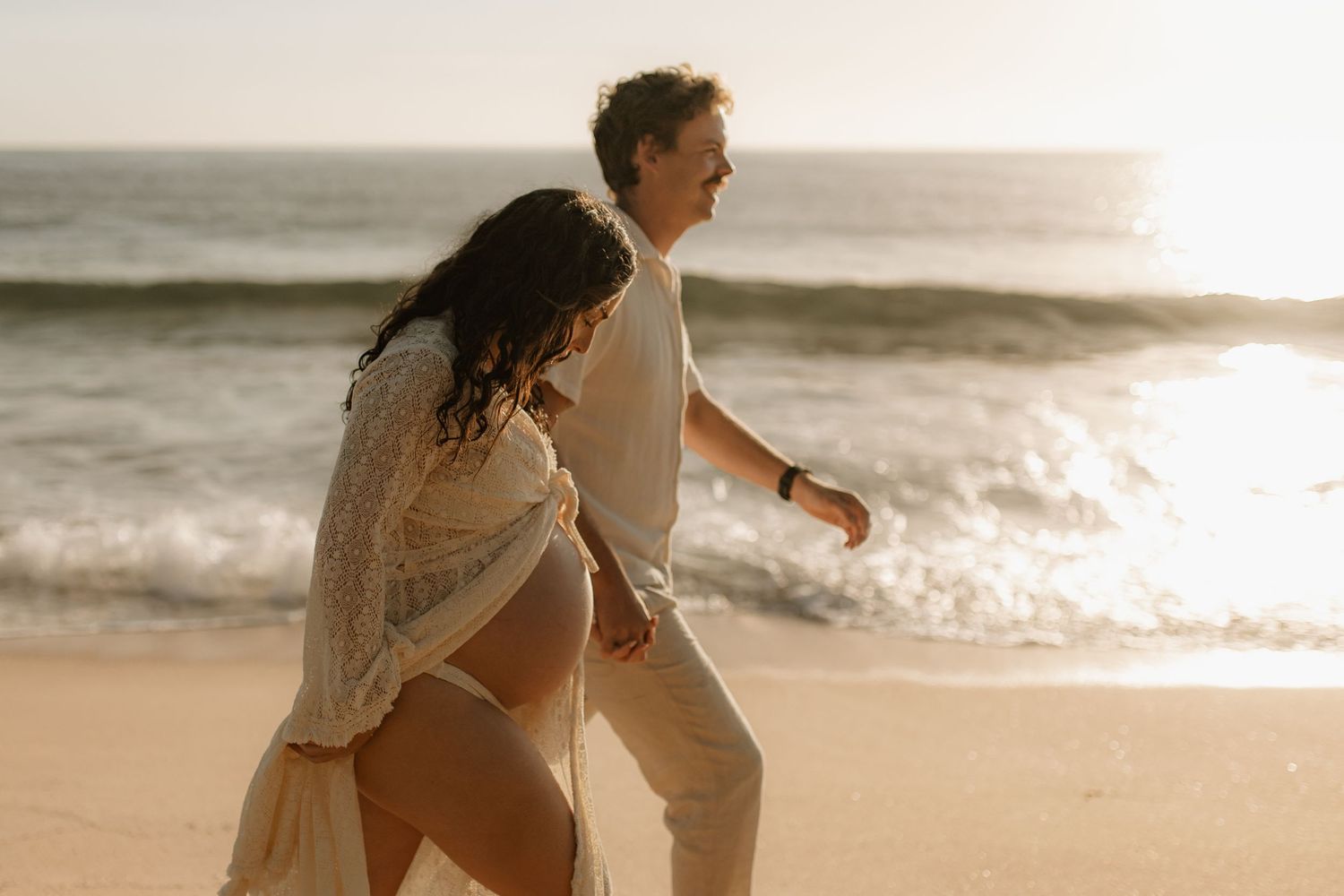 couples sunrise maternity session at the beach