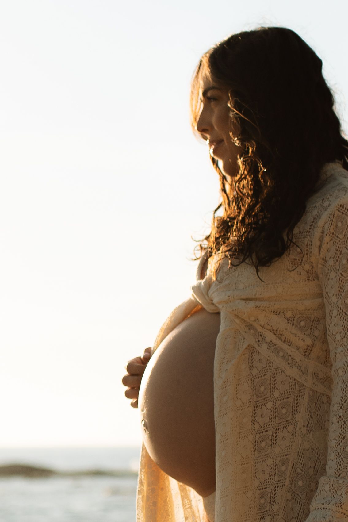 couples sunrise maternity session at the beach