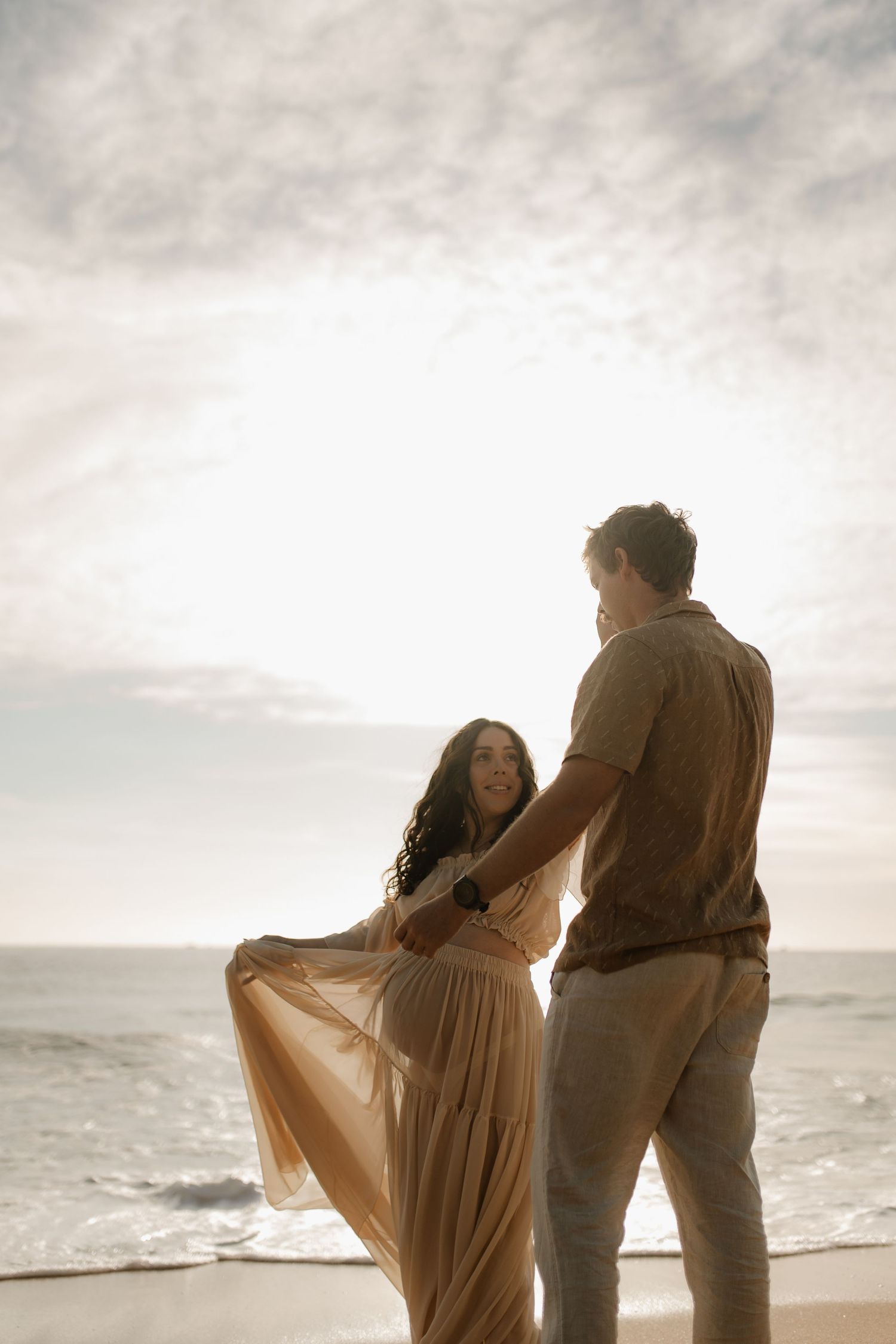 couples sunrise maternity session at the beach
