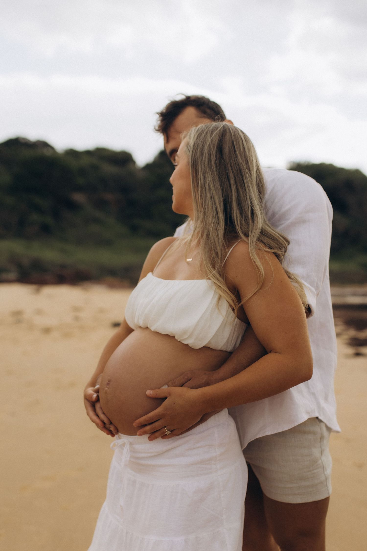 couples maternity session at the beach