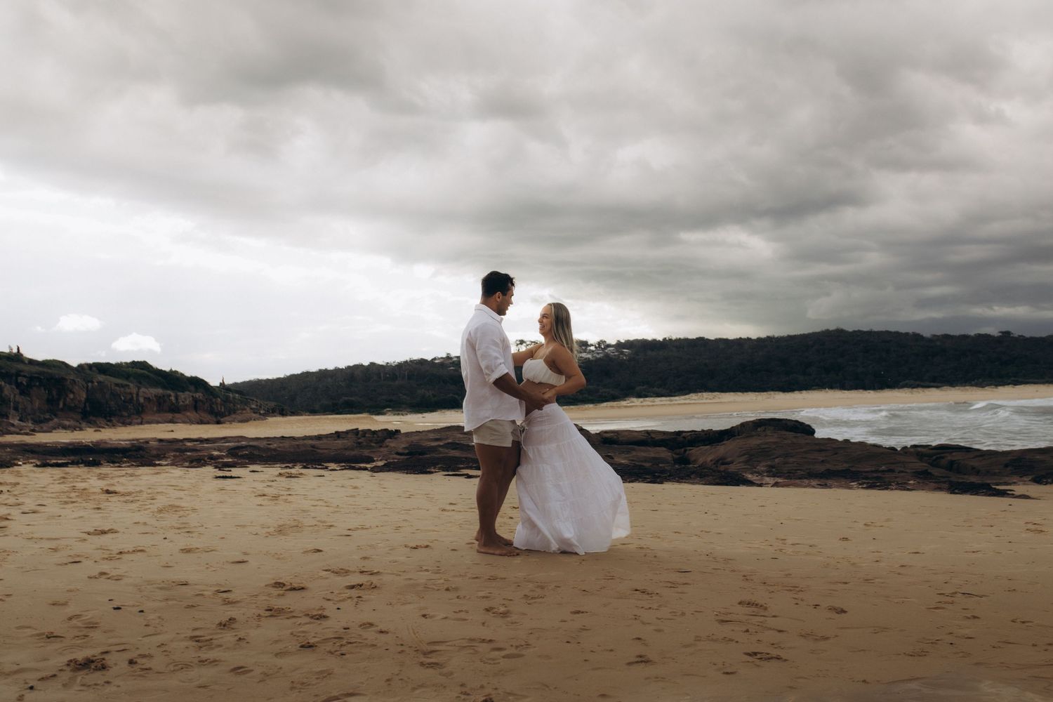 couples maternity session at the beach