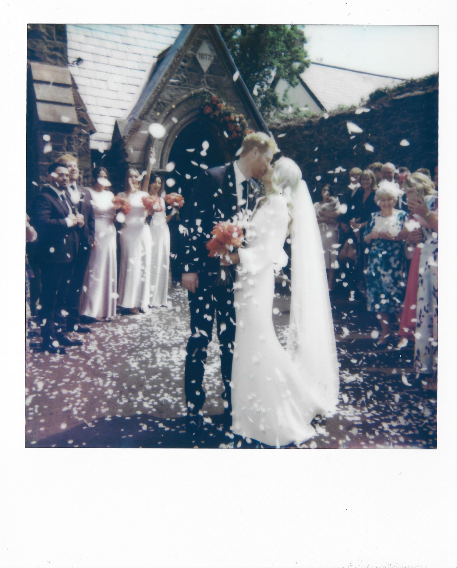 Newlyweds celebrate their first dance as confetti falls around them in a joyous wedding reception moment.