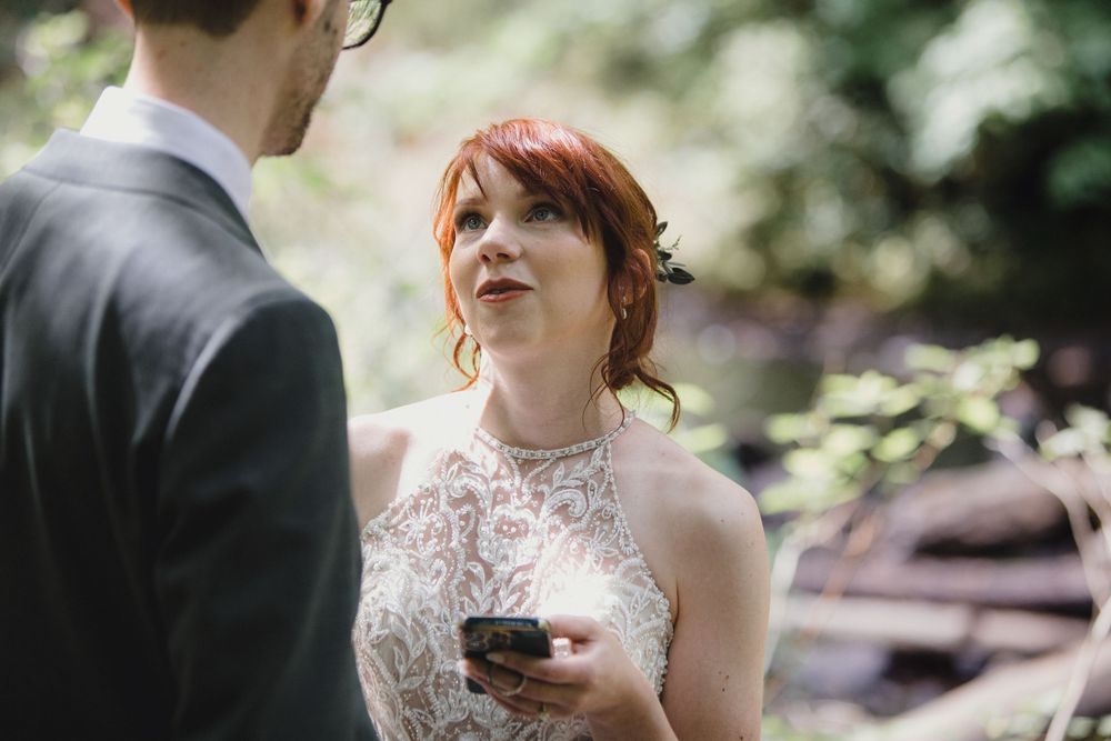 A joyful moment captured during an outdoor wedding ceremony in a lush garden setting.