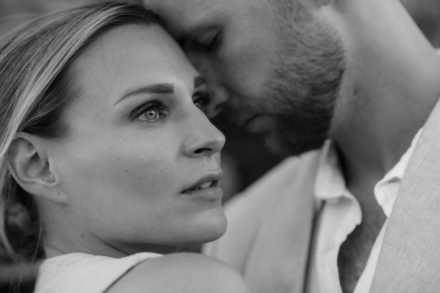 Black and white close up photo of a tender romantic moment between a couple.