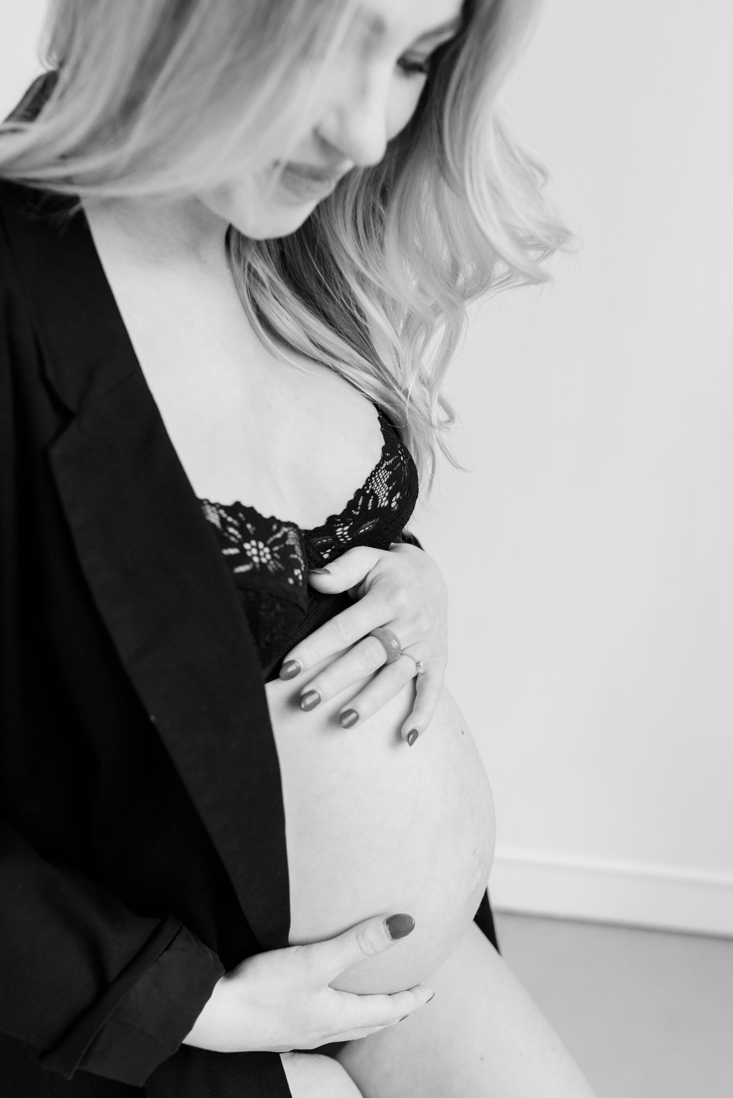 Artistic black and white portrait series featuring blonde hair and dark clothing against a light background.